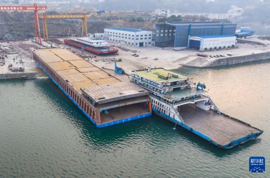 1月20日，秭歸縣華星船務有限公司建造的新能源滾裝船從制造平臺向江上移動（無人機照片）。新華社發（鄭家裕攝）