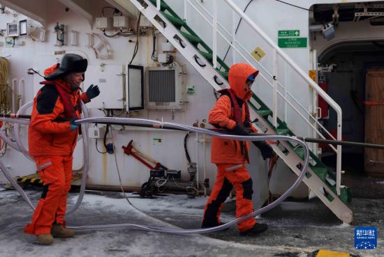 3月29日，中外科考隊員在“雪龍2”號上合作準備實驗器材。新華社記者 黃韜銘 攝