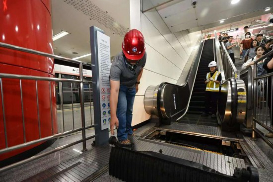 圖為北京市特種設備檢驗檢測研究院高級工程師韓志國近日在某一地鐵扶梯上拆解扶梯梯級。新華社發