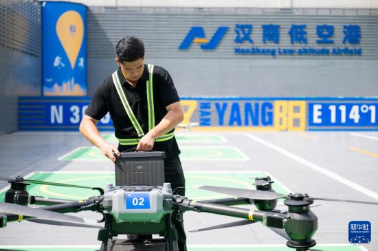 6月16日，在漢商低空港停機坪，一名工作人員給無人機更換電池。新華社記者 伍志尊 攝