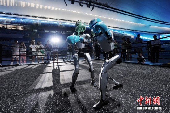 8月13日，在北京國家速滑館，兩臺宇樹科技機器人訓練自由搏擊項目。中新社記者 張祥毅 攝