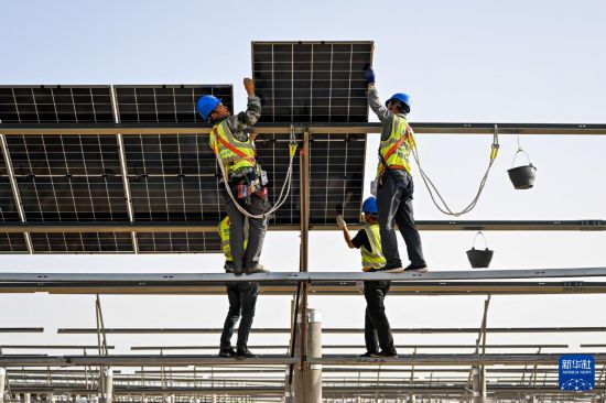 工人在庫布其沙漠里的杭錦旗朔方新能源大基地安裝光伏板（9月2日攝）。新華社記者 李志鵬 攝