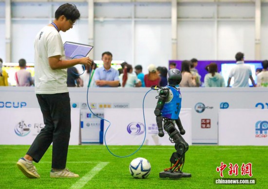 工作人員在賽前調試機器人。張進剛 攝