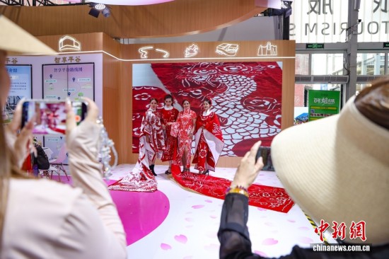 身著剪紙圖案服飾的演員吸引觀眾拍照。