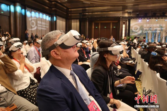   圖為開幕式上，參會者頭戴VR設備，觀看開場視頻。中新社記者 李一璠 攝